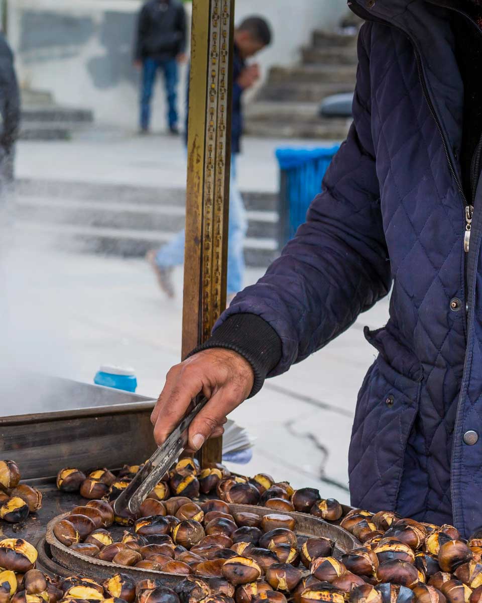 A person roasts chestnuts in Istanbul Turkey