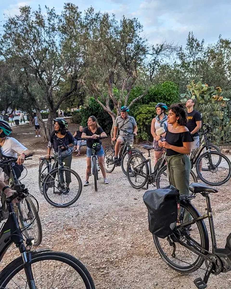 Athens by bike tours a guide talking to people on a bike tour in Athens Greece