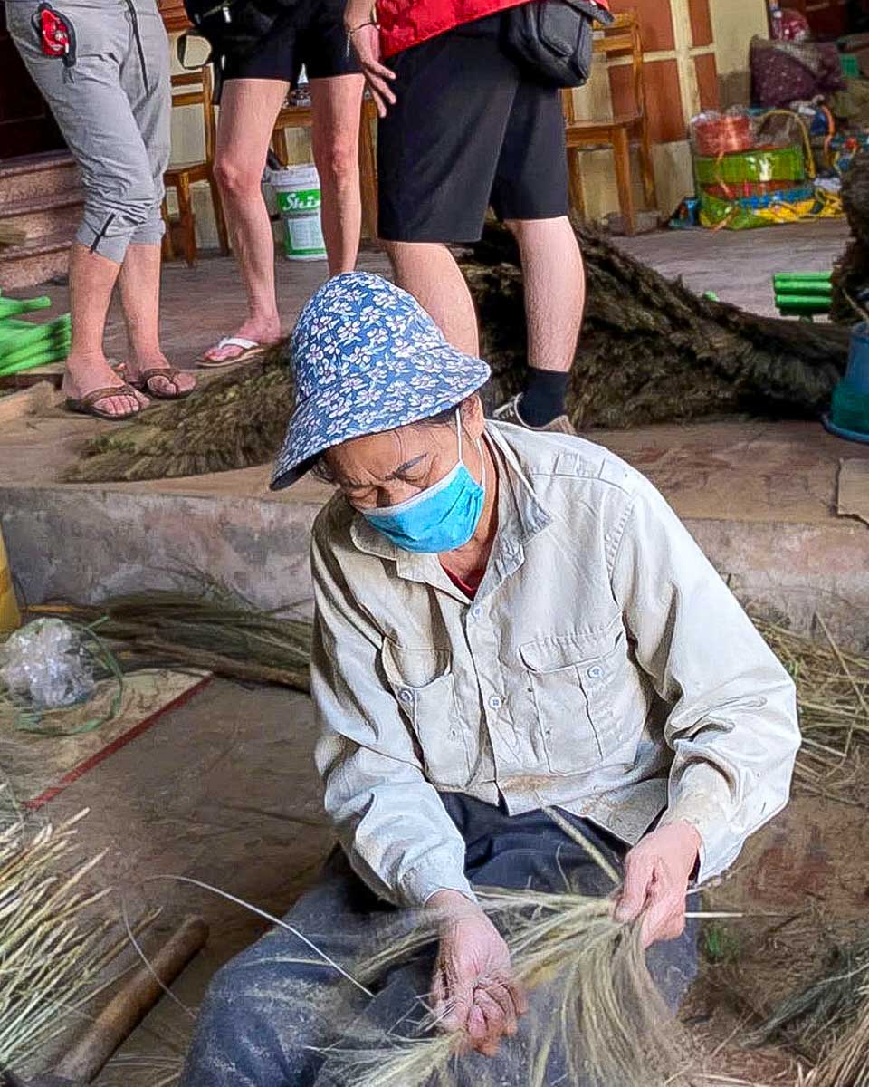 Bike Tours Hanoi a woman makes brooms near Hanoi Vietnam