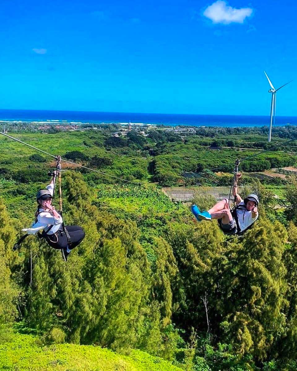 CLIMB Works Keana Farms people go down a zipline in Oahu Hawaii