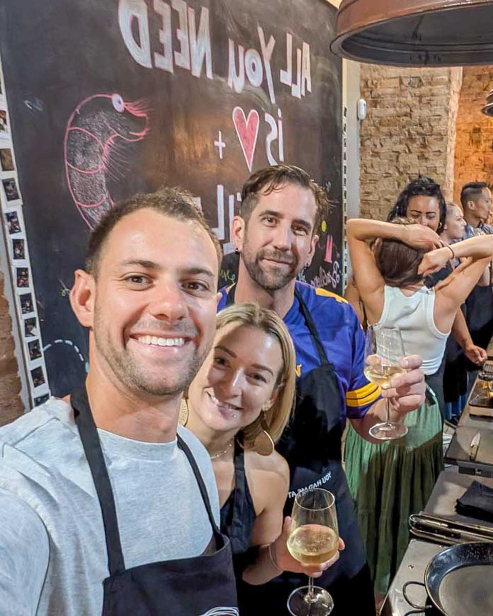 Daniel-and-Bailey-smiling-in-a-kitchen-during-a-Paella-making-class-in-Madrid-Spain
