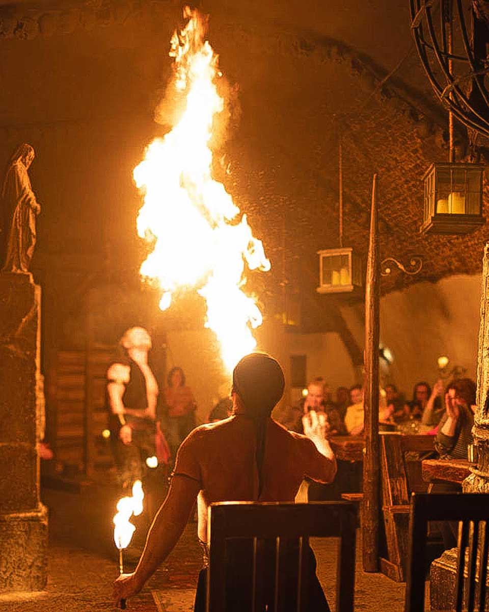Fun in Prague person blows fire in dinner hall prague czech republic