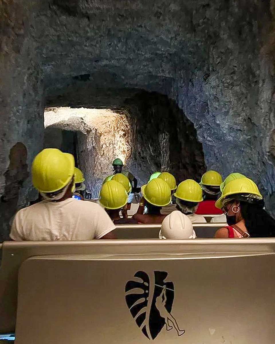 Harrison's Cave Barbados people in vehicles in a cave on a tour from Barbados