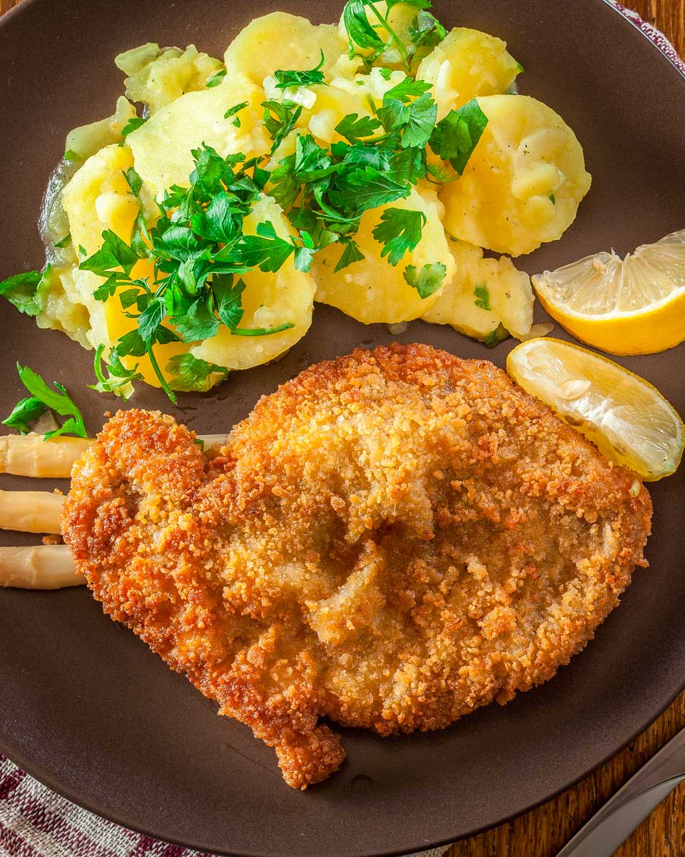 Homemade breaded viennese schnitzel made during a cooking class in Vienna Austria