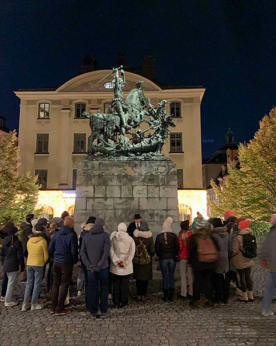 Stockholm Ghost Walk people at Saint George and the Dragon Statue in Stockholm Sweden