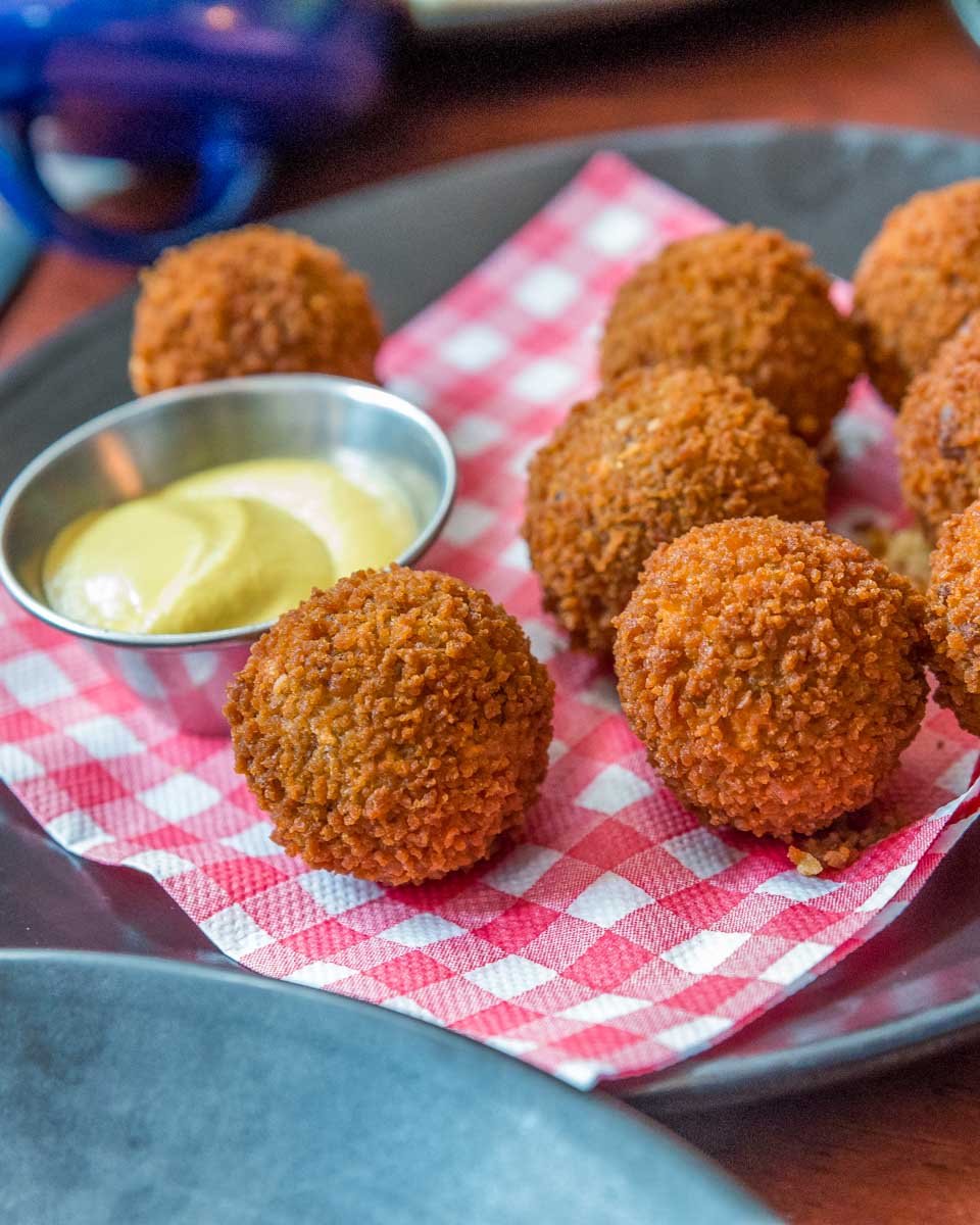 Trying bitterballen food in Amsterdam Netherlnds