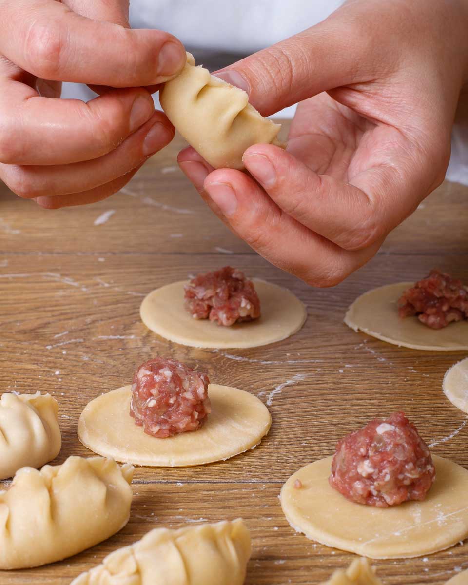 A person making dumplings during a cooking class in Hong Kong