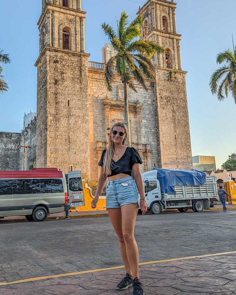 Bailey-poses-for-a-photo-in-front-of-the-cathedral-in-Valladolid-Mexico on a tour to Chichen Itza