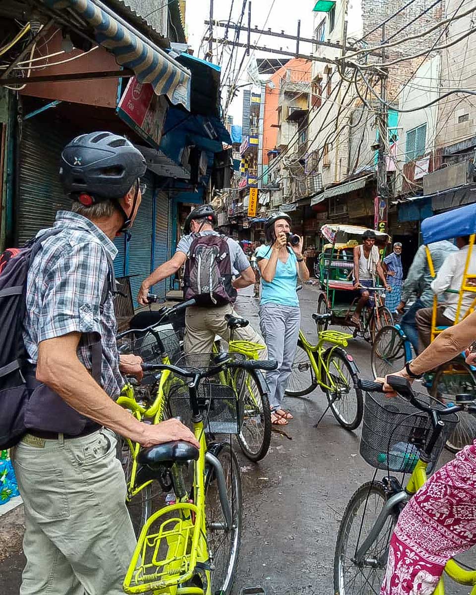 Delhi By Bike people ride bikes in Old Delhi on a tour in New Delhi