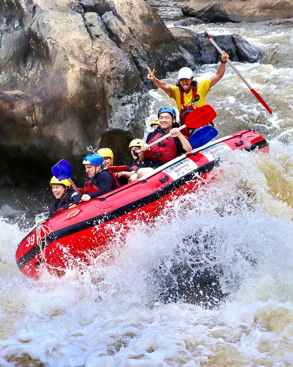 Foaming Fury people go down a river on a rafting tour from Cairns Australia