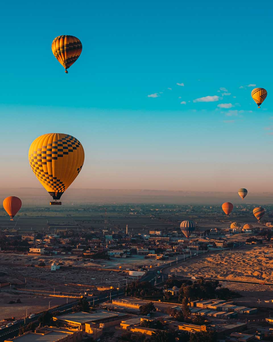 Hot air balloons during sunrise on a tour from Luxor Egypt
