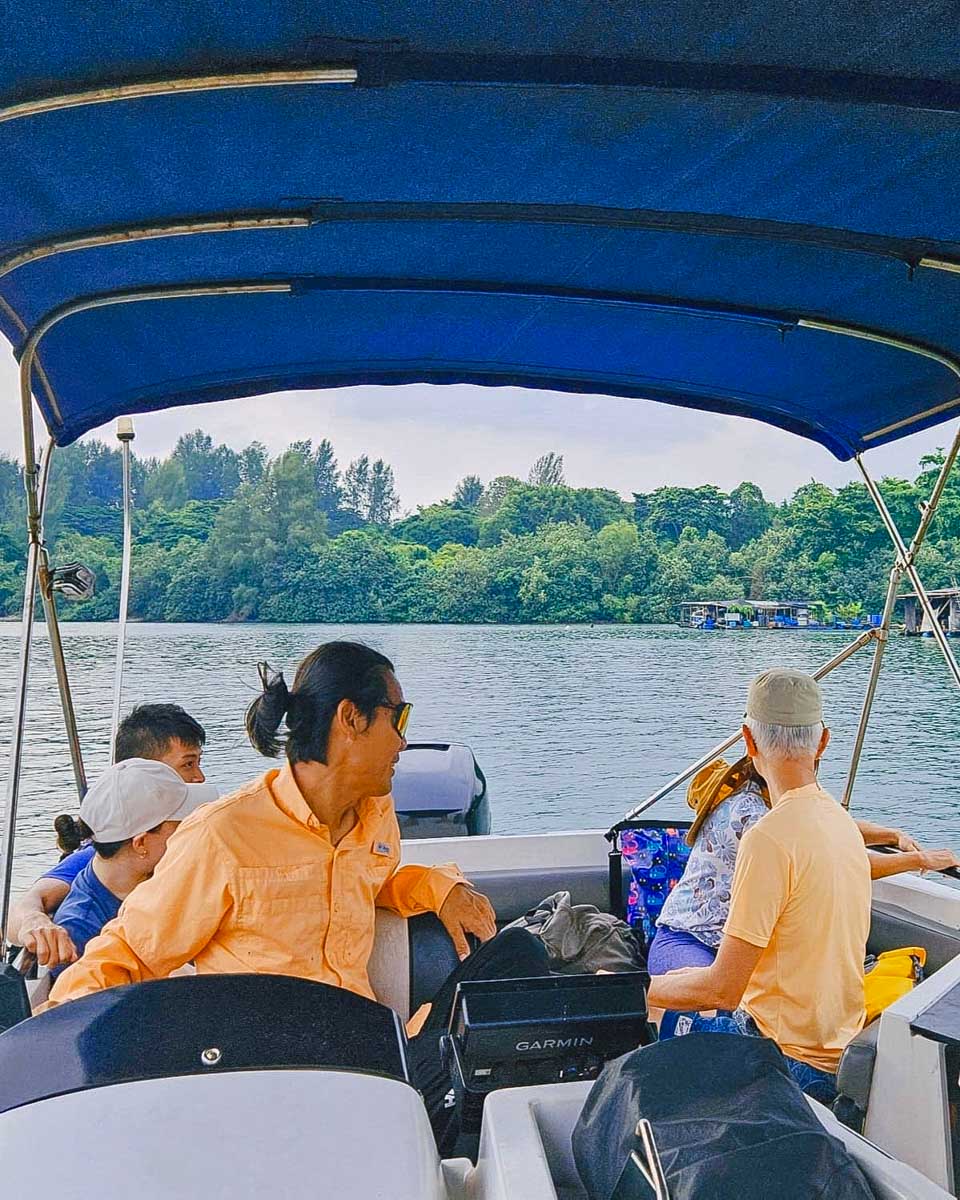 Let's Go Tour Singapore a guide drives a boat to Pulau Ubin on a tour from Singapore