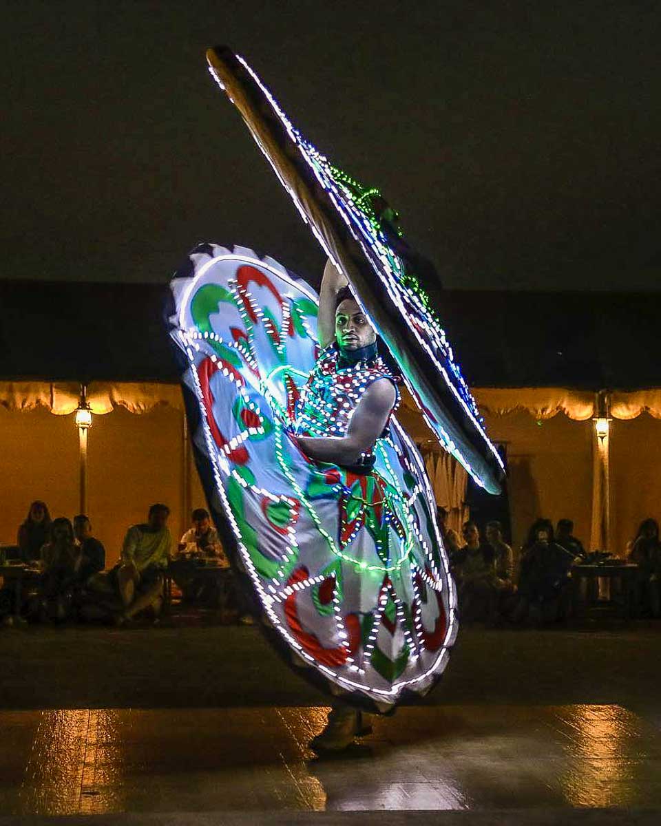 OceanAir Travels a man dances at night on a tour from Dubai