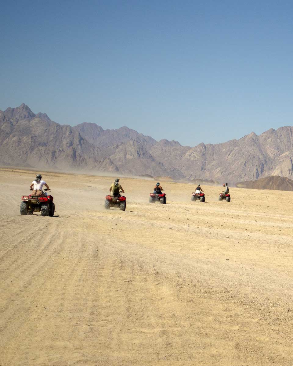 People ride through the desert on atvs on a tour from Luxor Egypt