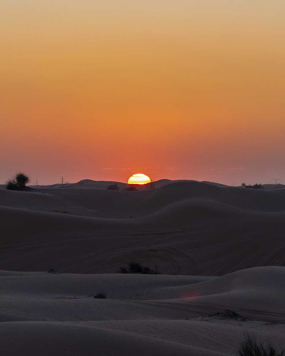 Sunset seen in the desert on a tour from Abu Dhabi