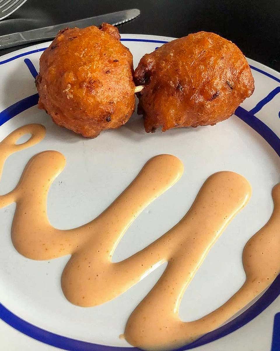 Tru Bahamian Food Tours conch fritters eaten on a food tour in Nassau Bahamas