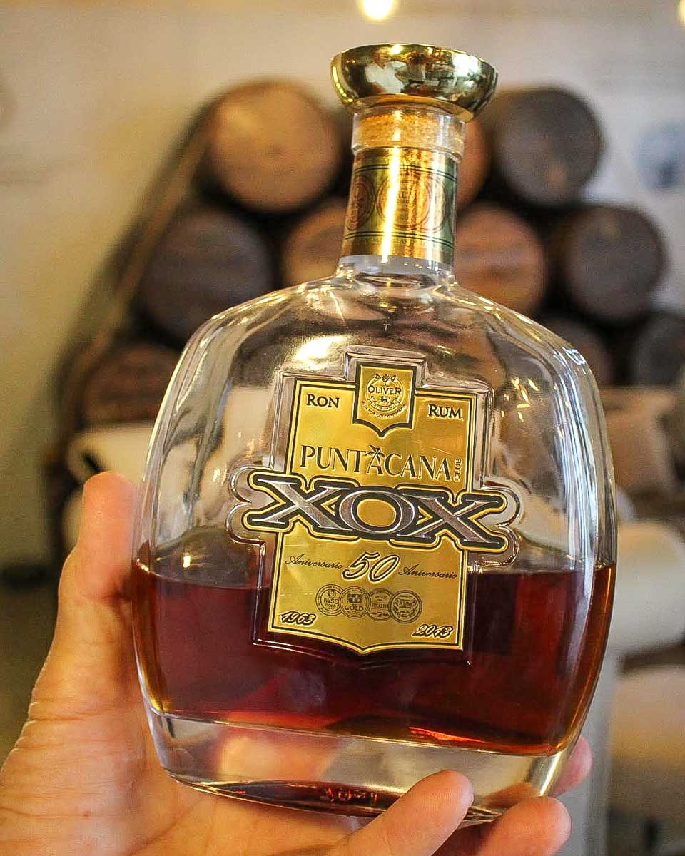 tainogourmet a person holds rum on a tour from Punta Cana Dominican Republic