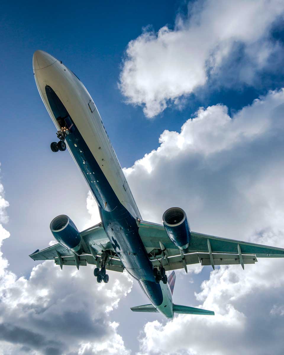 A plane flies low at Maho Beach on a tour of St Maarten