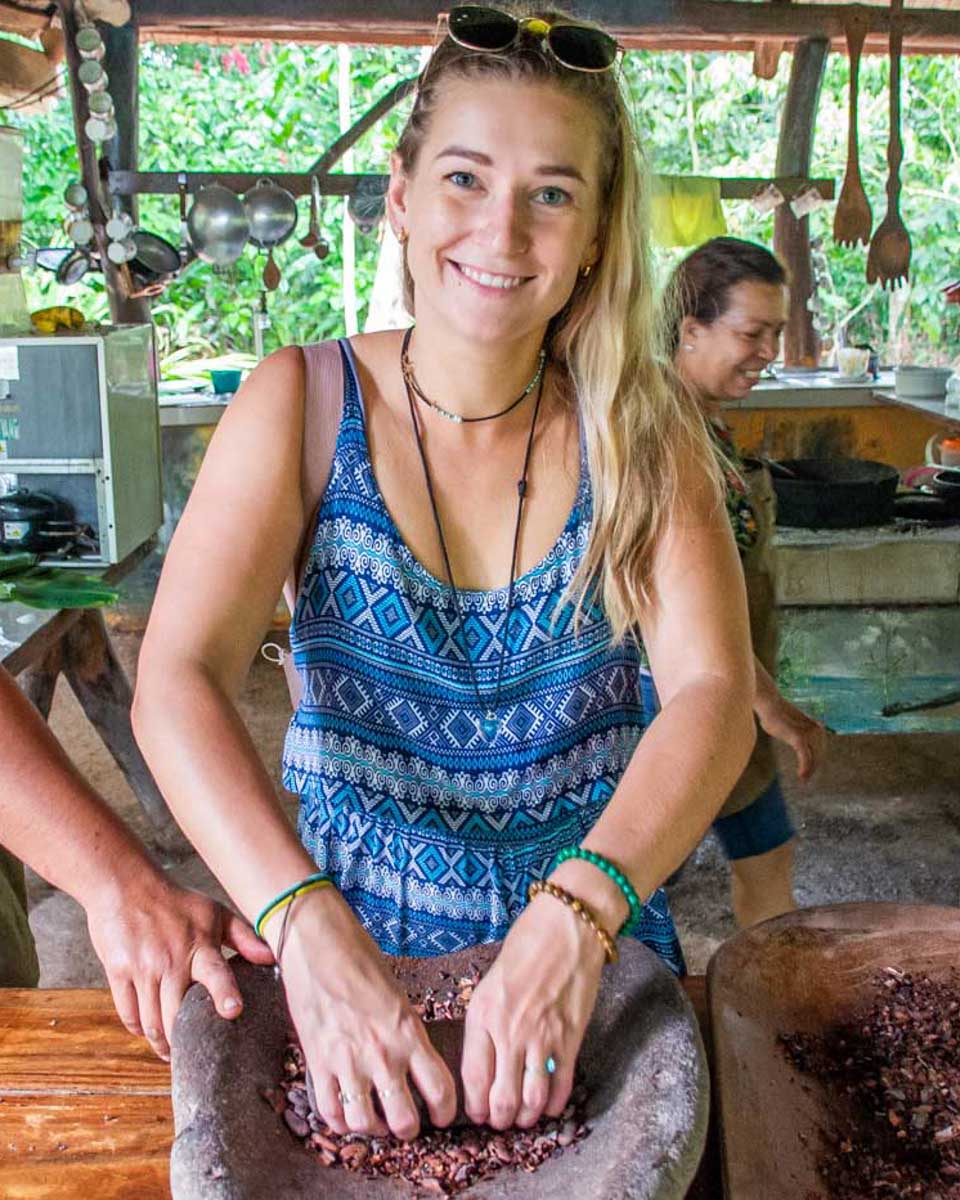 Bailey-grinds-cocao-a-traditional-way-in-Roatan Honduras