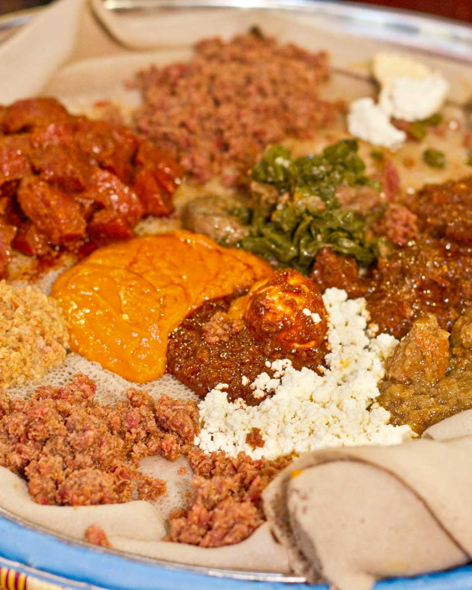 Injera and traditional Ethiopian food eaten on a food tour in Addis Ababa Ethiopia