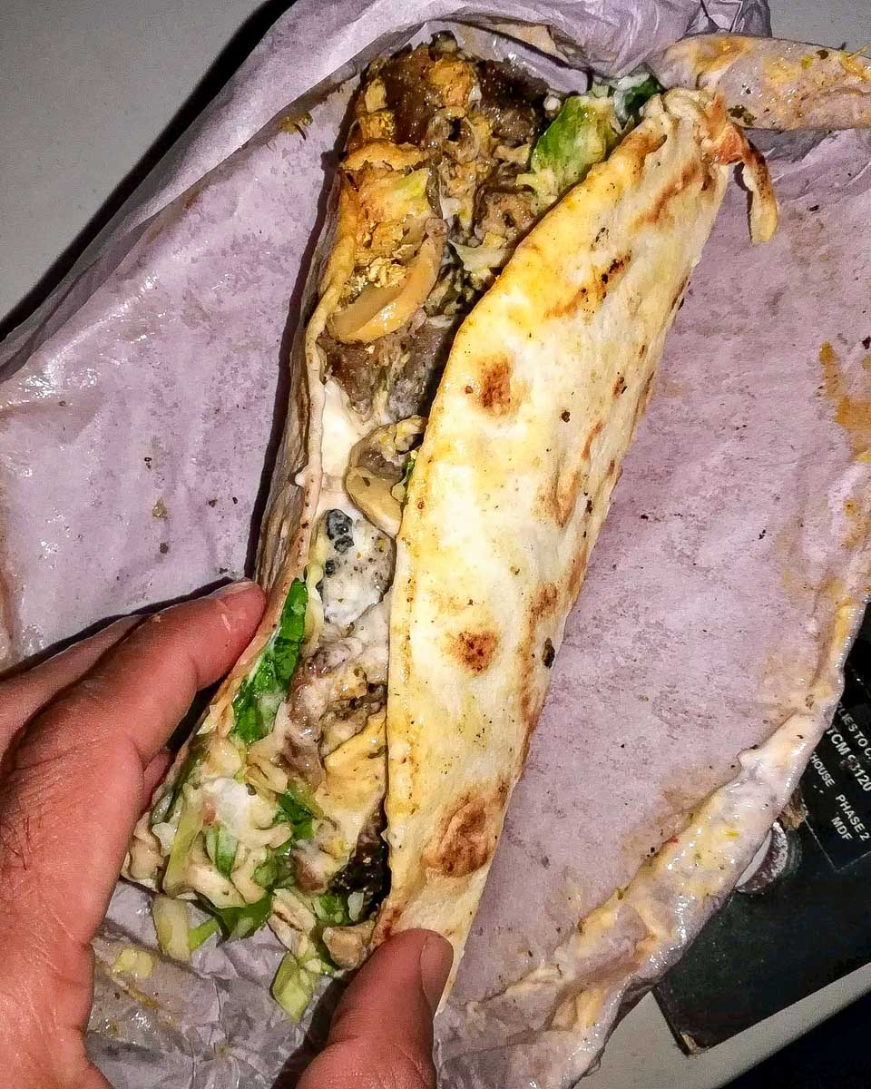 Trinidad Food Tours a person eats food on a tour in Trinidad