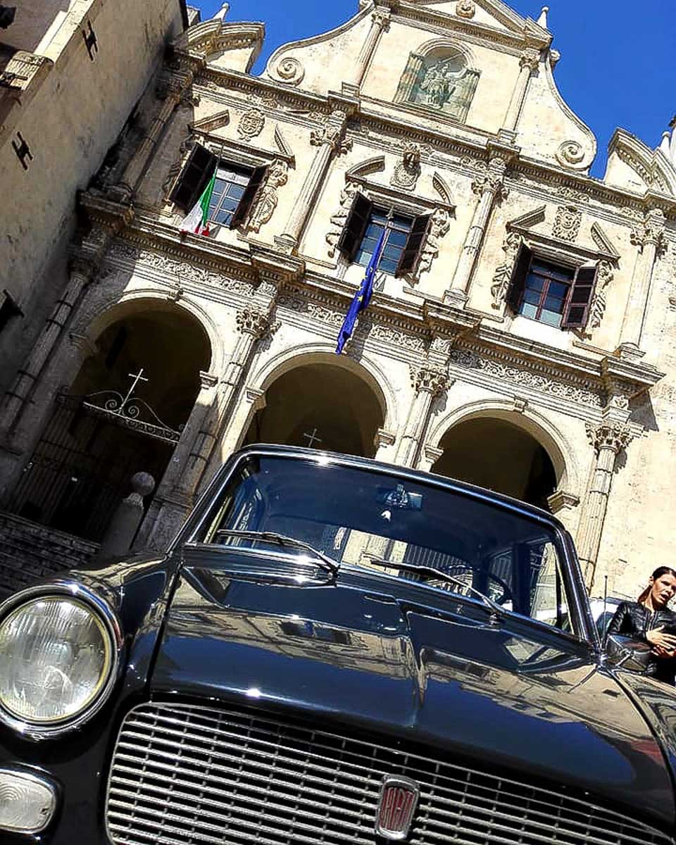 A black 1964 Fiat used as transportation on a private tour in Cagliari Italy