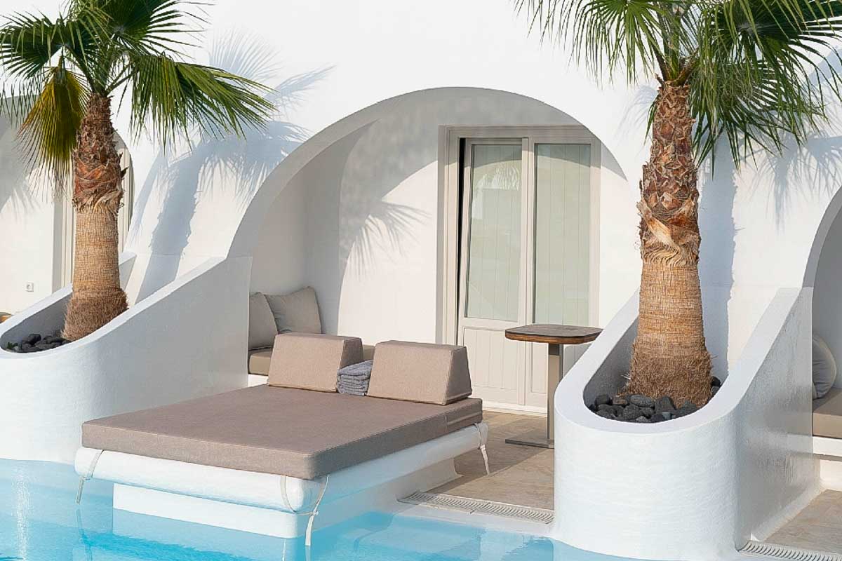 A day bed at the outdoor pool at Santorini Kastelli Resort in Santorini Greece