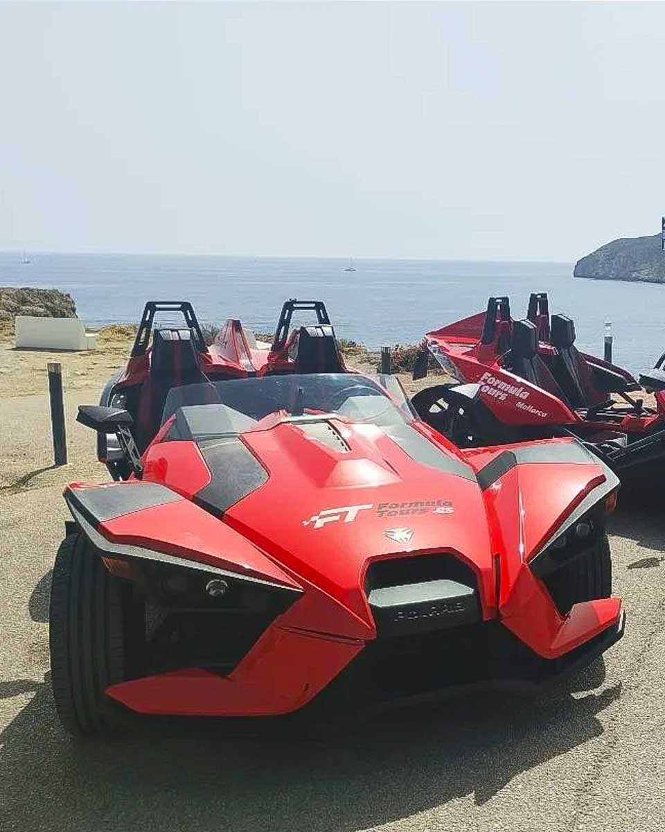 Formula 1 Cars with the sea in the background on a Formula Tour in Mallorca Spain
