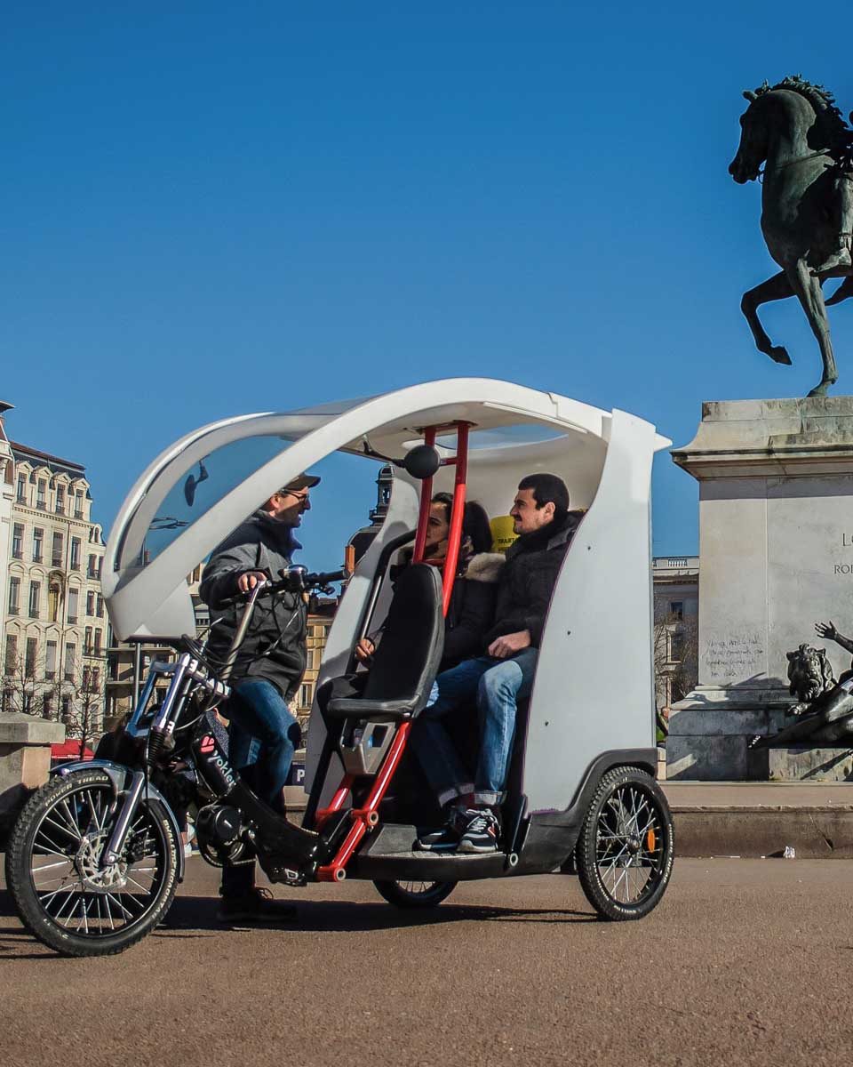 People in the Pedicab on a tour with Lyon Pedicap Tours in France