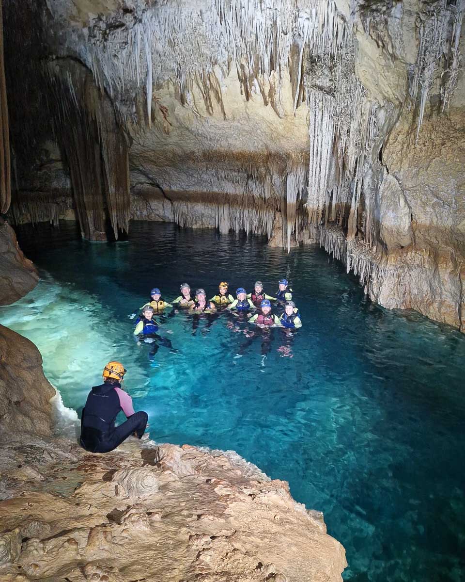 People swim in the underground cave on a tour near Palma de Mallorca Spain