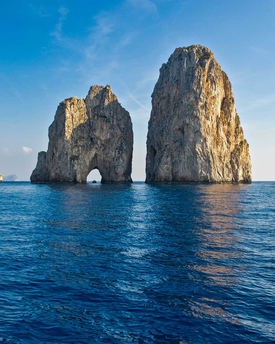 The famous Faraglioni rock formation off of the coast of Capri seen on a tour from Sorrento Italy