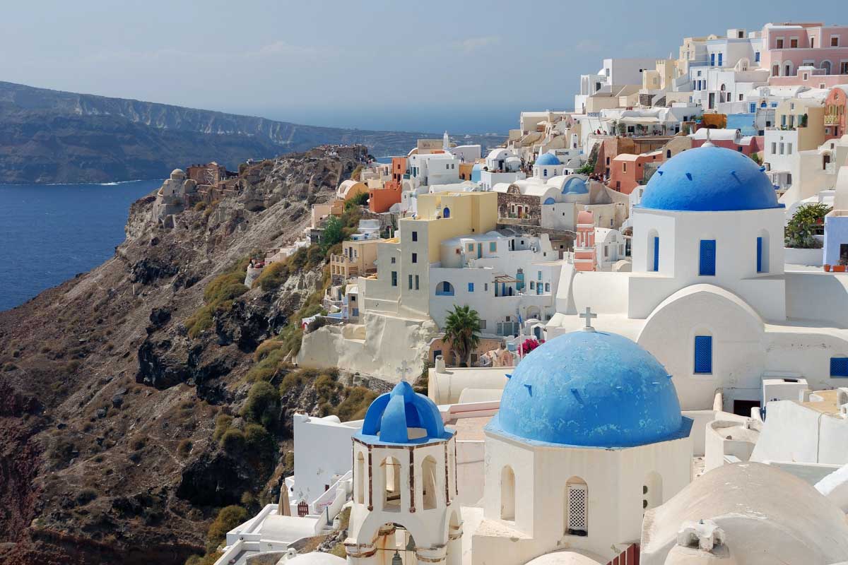 White and blue houses seen on the coastline of Santorini Greece