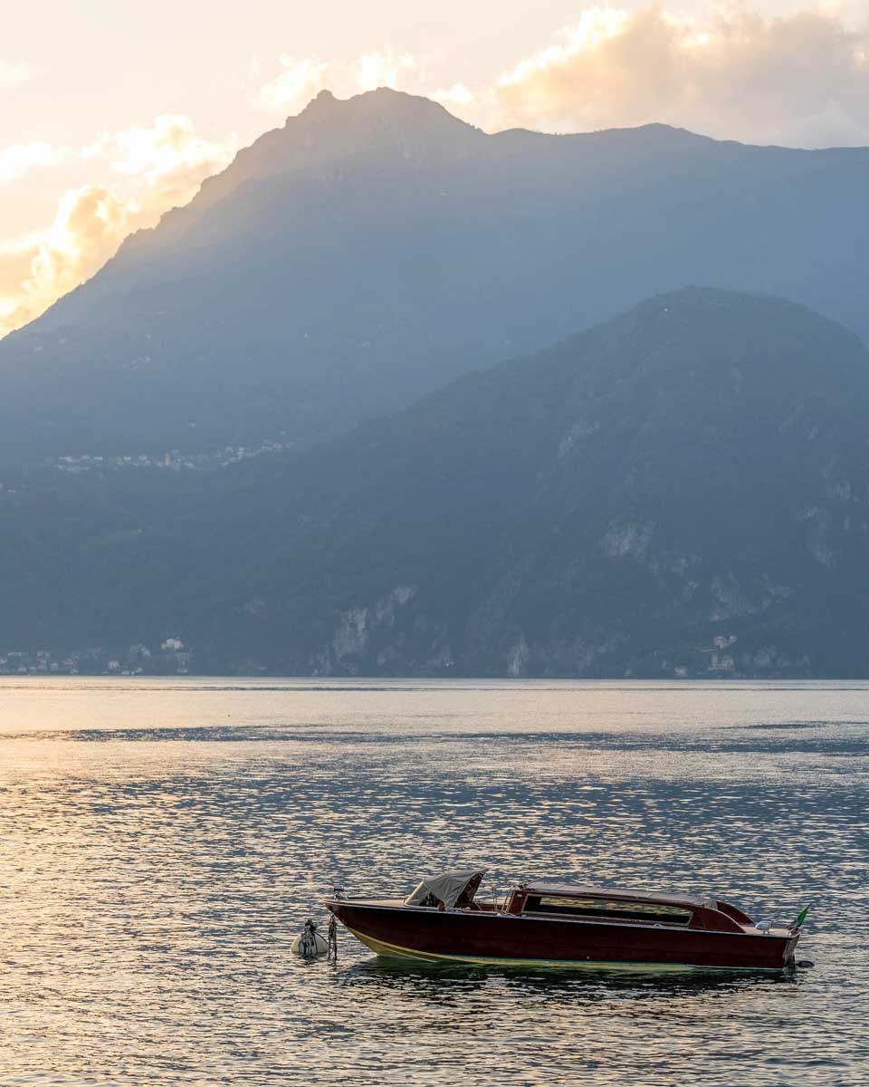 A boat on Lake Como at sunset in Italy