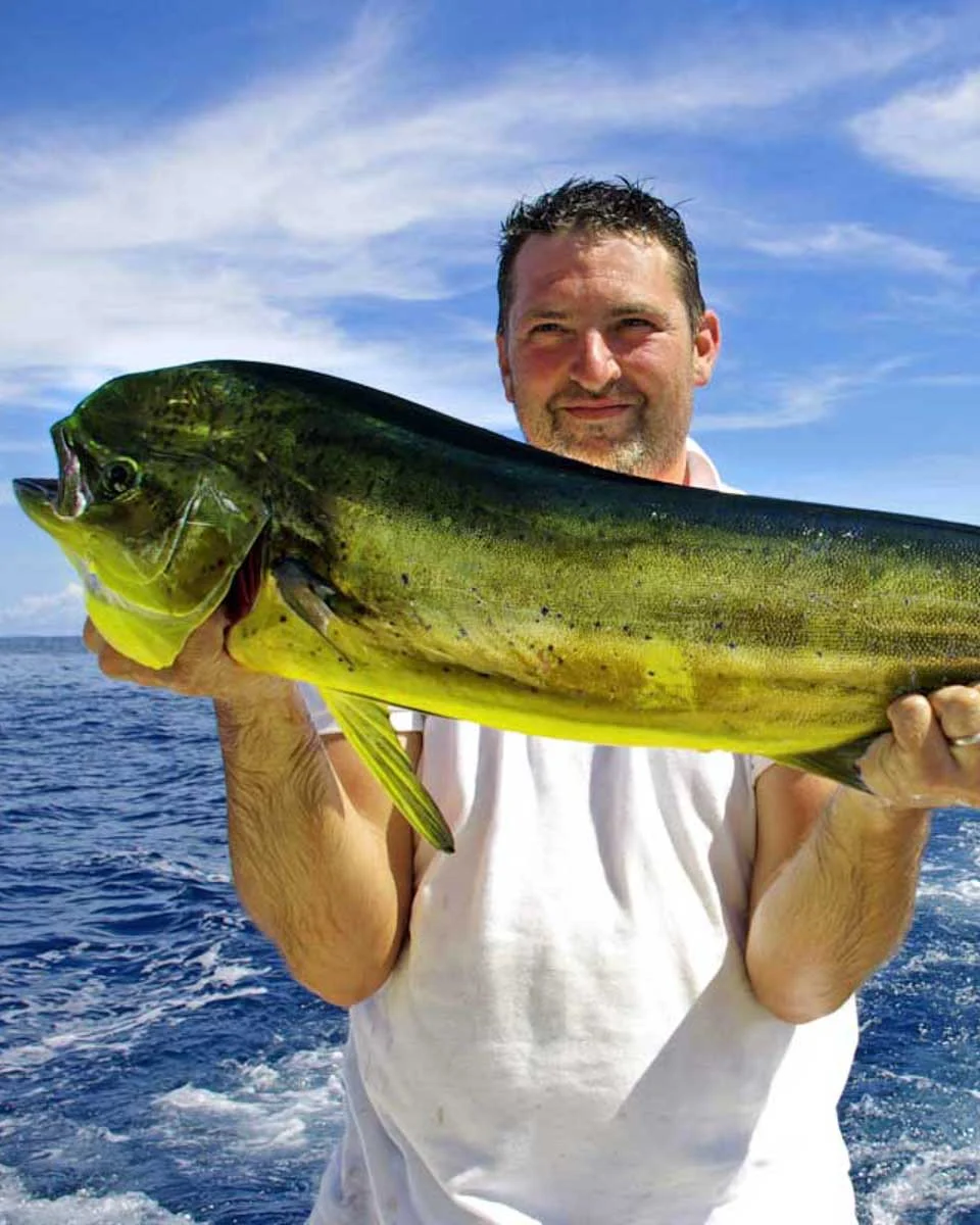 A-man-holds-a-mahi-mahi-fish-on-a-fishing-tour-in Fort Lauderdale-Florida