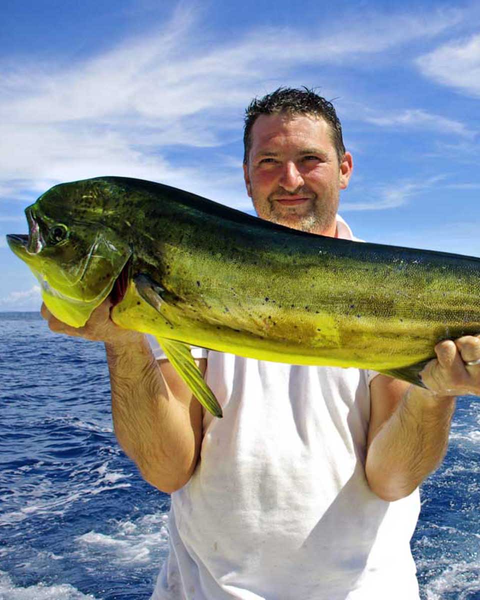 A-man-holds-a-mahi-mahi-fish-on-a-fishing-tour-in-Tampa Florida