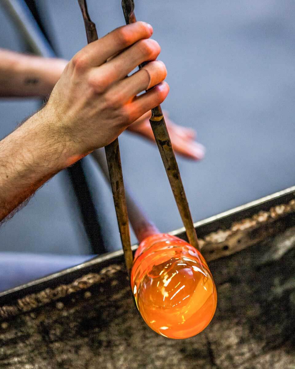 A man moulds glass at a glass blowing experience in Sedona Arizona