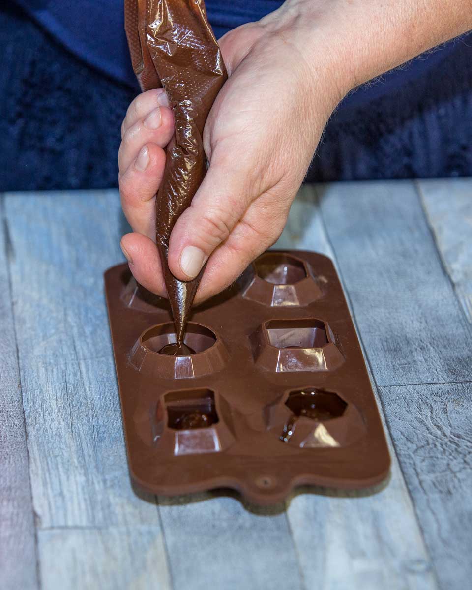 A person making chocolate during a tour in Bruges Belgium