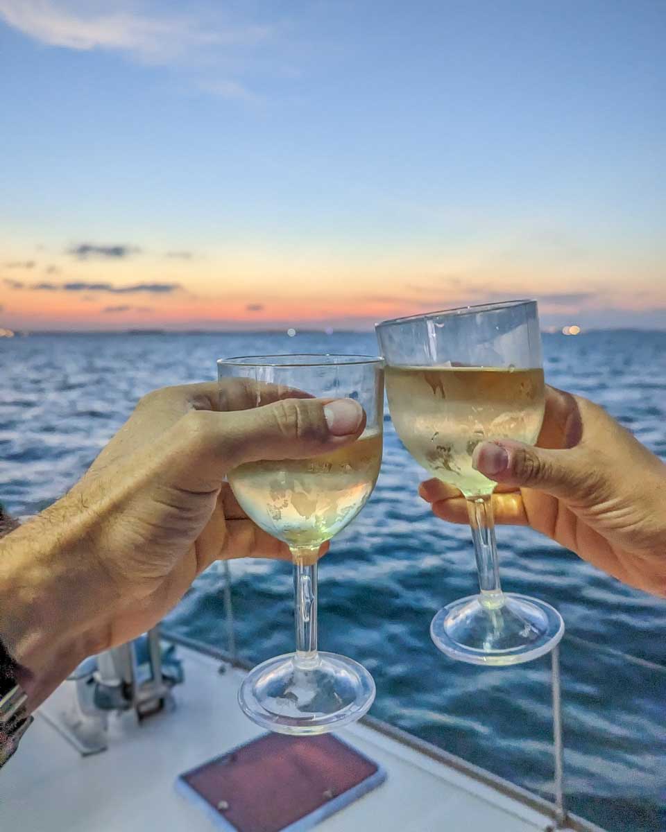 Bailey-and-Daniel-cheers-with-wine-at-sunset-on-a-cruise-in-Naples Florida