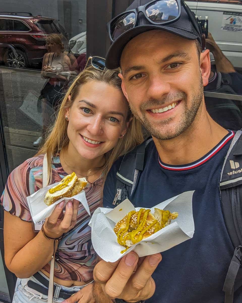 Bailey-and-Daniel-take-a-selfie-with-their-fresh-pretzels-during-a-food-tour-in-Seattle Washington