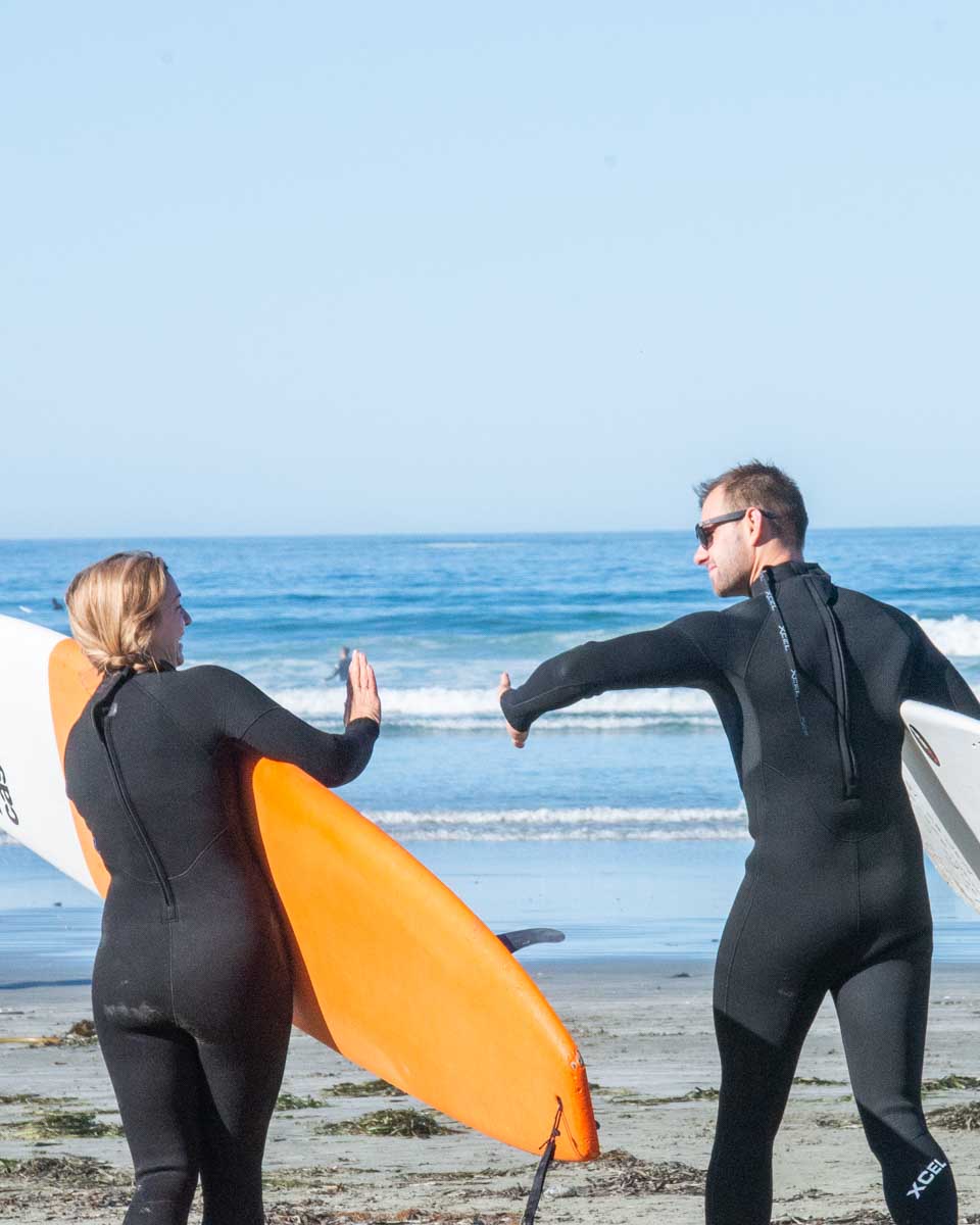 Daniel-and-Bailey-high-five-before-going-out-for-a-surf-in-Lagos-Portugal