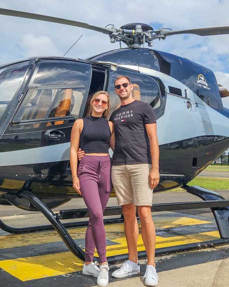 Daniel-and-Bailey-pose-for-a-photo-in-front-of-their-helicopter-tour-in-Orlando Florida