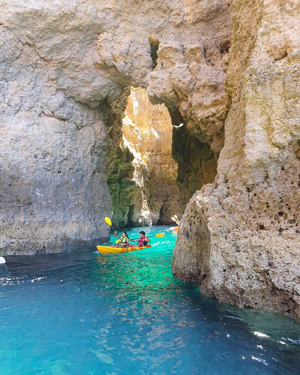 People kayaking through the Ponta da Piedade on a tour from Lagos Portugal