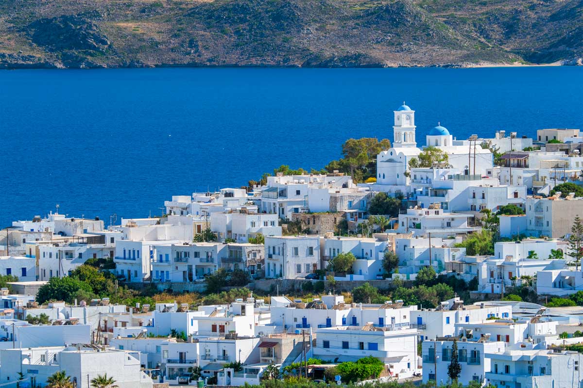 View of Plaka village with traditional Greek church in Milos Greece
