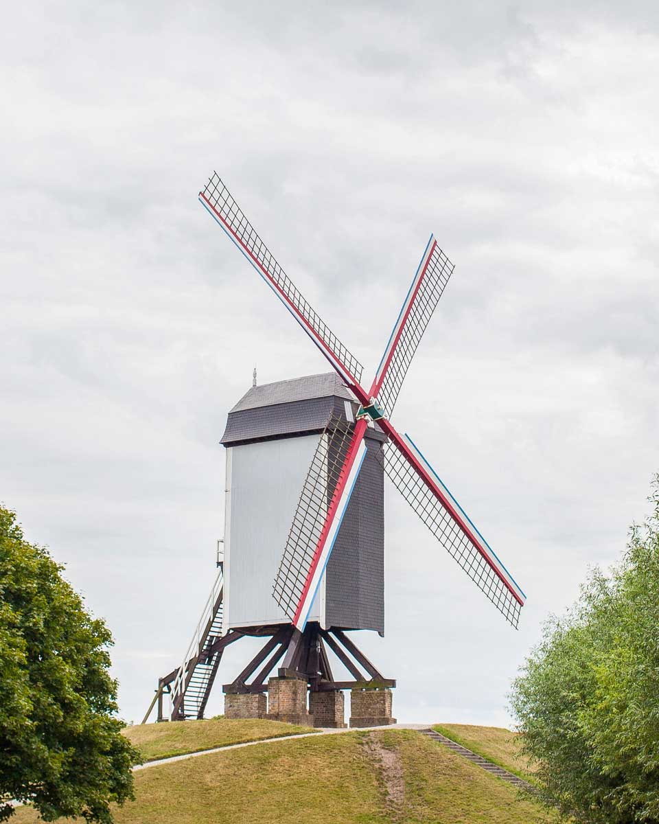 Windmill Sint Janshuismolen seen on a bike tour in Bruges Belgium