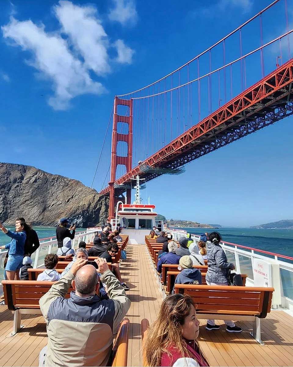 A boat going under the Golden Gate Bridge in San Francisco