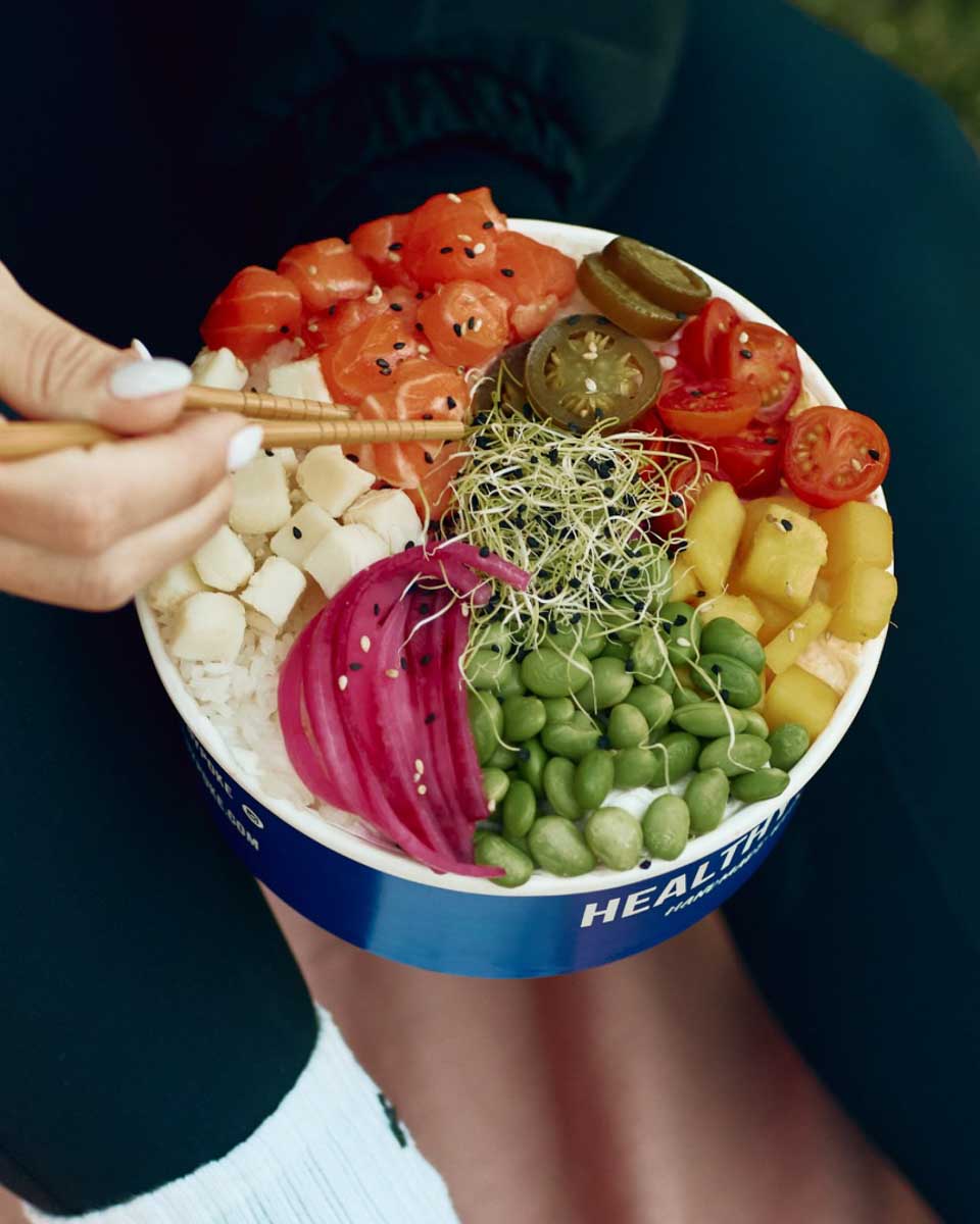 A person eats a poke bowl at Healthy Poke Seville