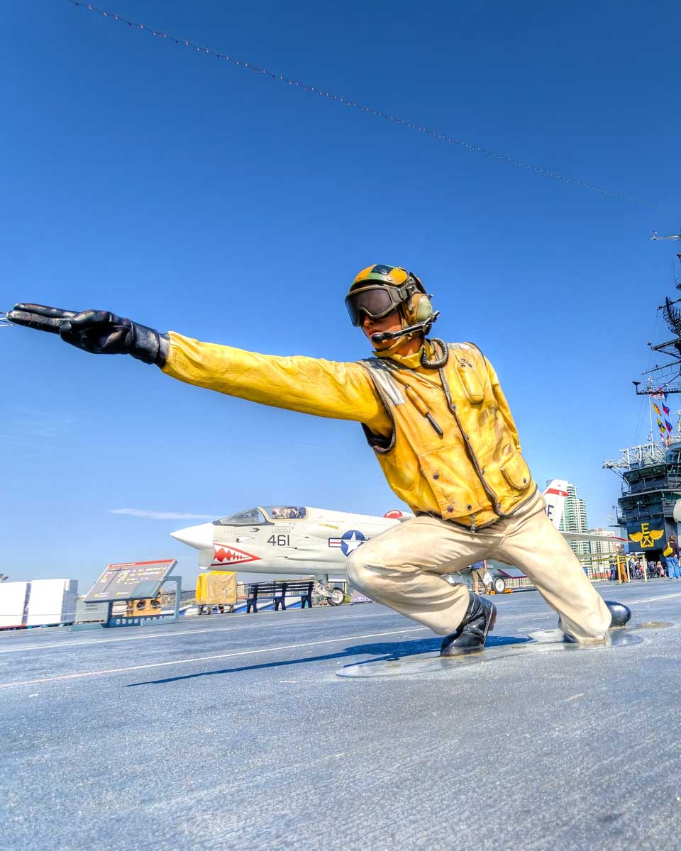 A statue of a flight deck director at the USS Midway Museum in San Diego