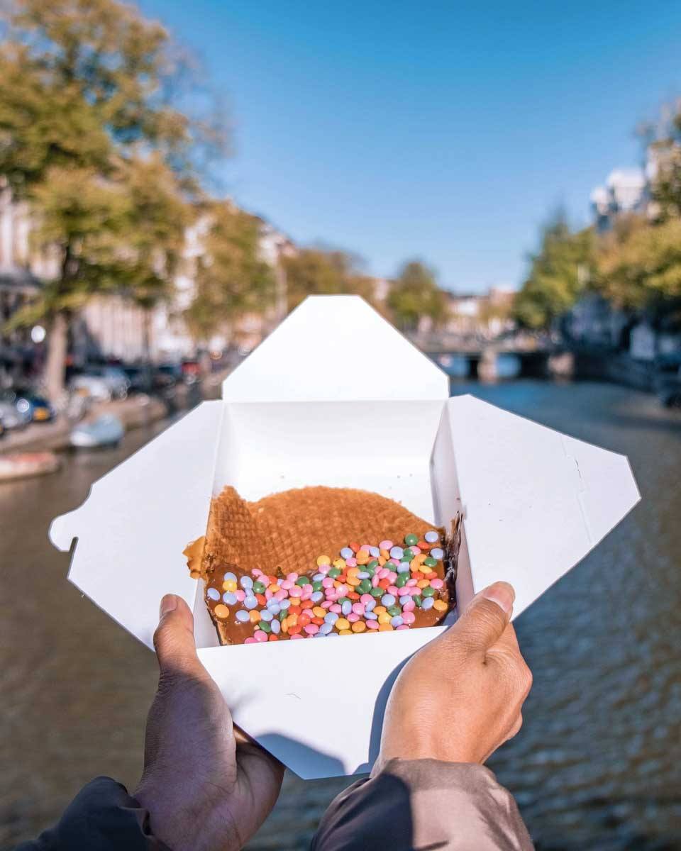 A stroopwaffel with the canal in the background in Amsterdam