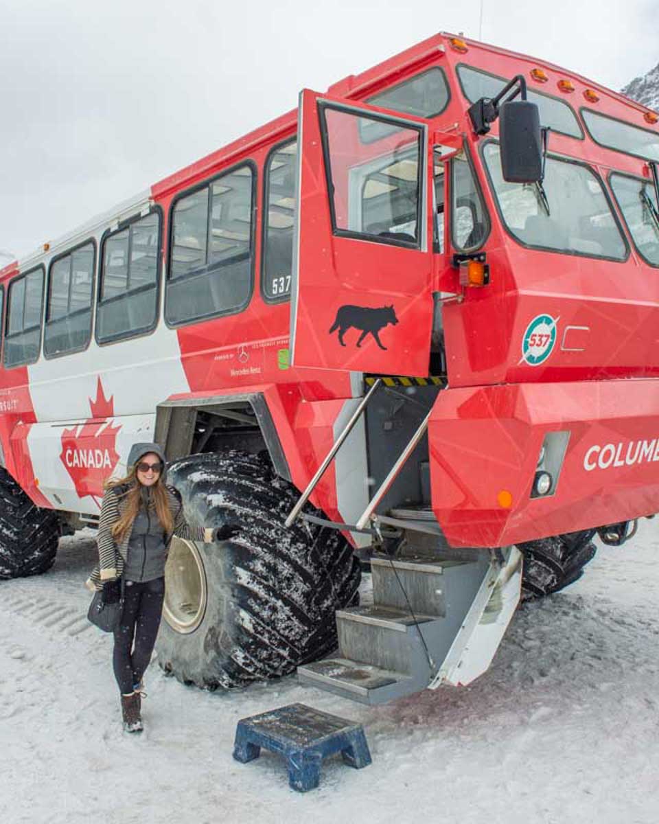 Bailey-poses-for-a-photo-with-an-Ice-Explorer-all-terrain-vehicle-on-the-Athabasca-Glacier-in-the-Columbia-Icefield-Canada