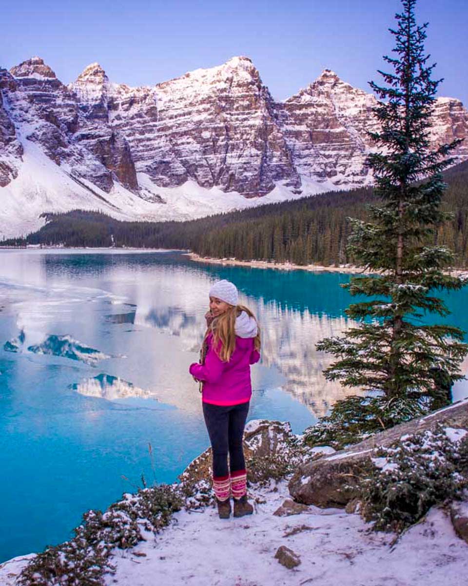 Bailey-stands-on-the-edge-of-Moraine-Lake-in-Banff-National-Park-at-sunrise